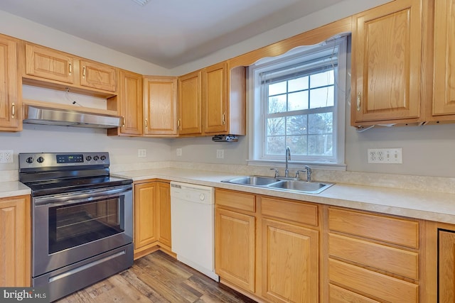 kitchen featuring electric range, dishwasher, sink, wood-type flooring, and light brown cabinetry