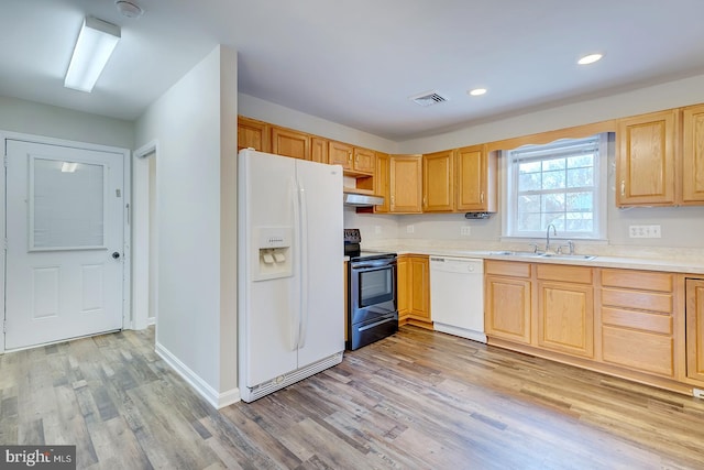 kitchen featuring light brown cabinets, white appliances, light hardwood / wood-style floors, and sink