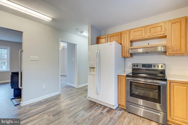 kitchen with light hardwood / wood-style floors, white refrigerator with ice dispenser, and electric stove