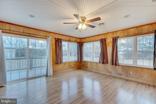 unfurnished sunroom featuring ceiling fan