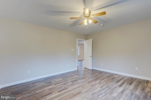 empty room with ceiling fan and light hardwood / wood-style floors