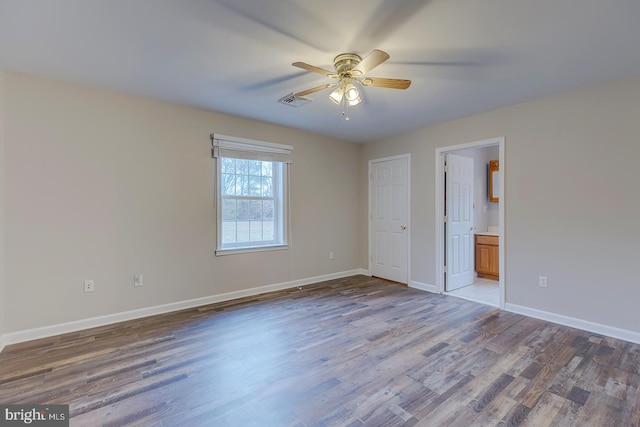 spare room featuring ceiling fan and hardwood / wood-style flooring