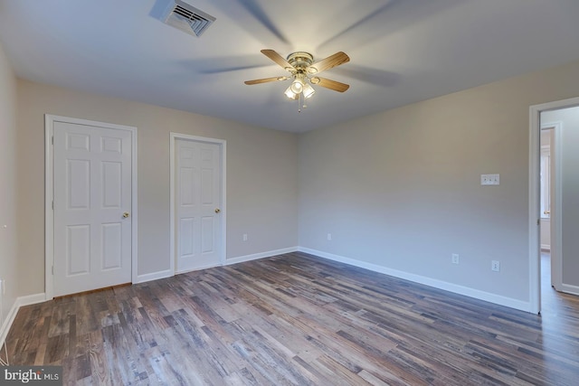 unfurnished bedroom with ceiling fan and dark hardwood / wood-style floors