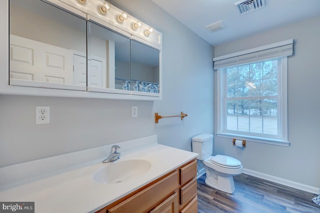 bathroom with hardwood / wood-style flooring, vanity, toilet, and a shower with shower curtain