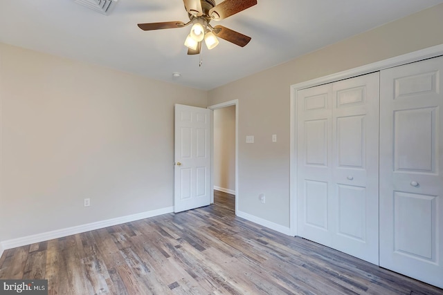 unfurnished bedroom featuring a closet, ceiling fan, and light hardwood / wood-style flooring