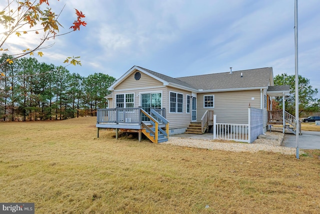 rear view of property featuring a lawn