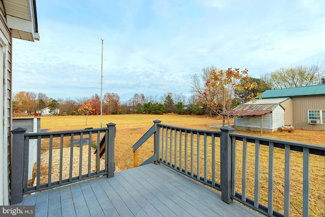 deck with a lawn and an outdoor structure