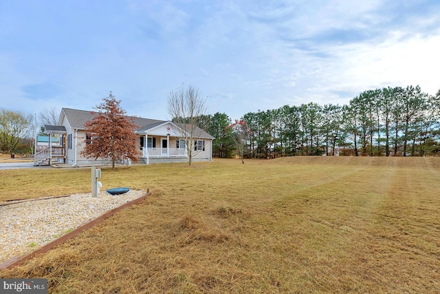 view of yard featuring covered porch