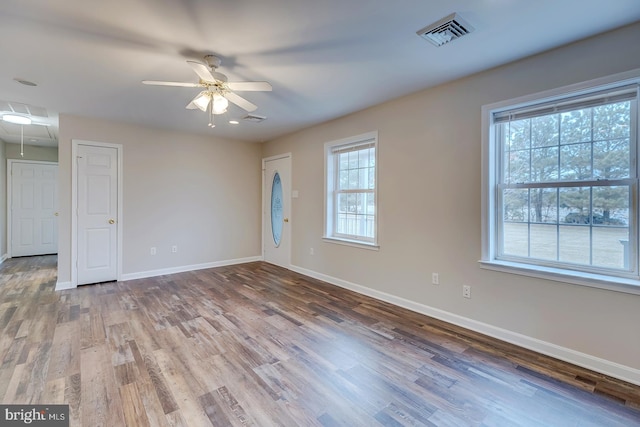 spare room featuring hardwood / wood-style flooring, plenty of natural light, and ceiling fan