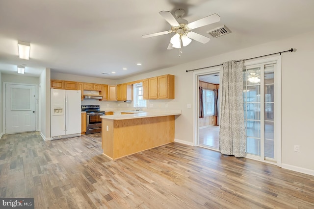 kitchen featuring stainless steel electric range, light hardwood / wood-style floors, white fridge with ice dispenser, and kitchen peninsula