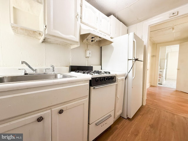 kitchen featuring white cabinets, light hardwood / wood-style floors, white range with gas cooktop, and sink