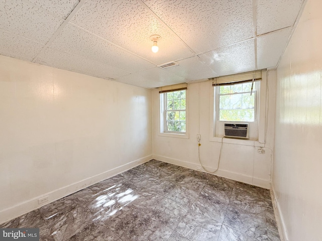 spare room featuring a drop ceiling and cooling unit