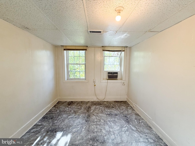 spare room featuring a drop ceiling and cooling unit