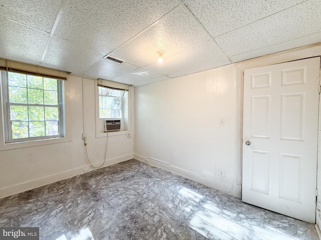 spare room featuring a drop ceiling and cooling unit