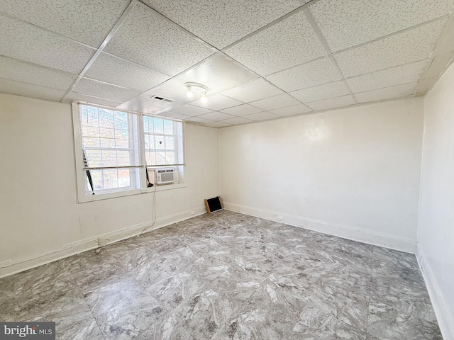 spare room featuring a paneled ceiling and cooling unit