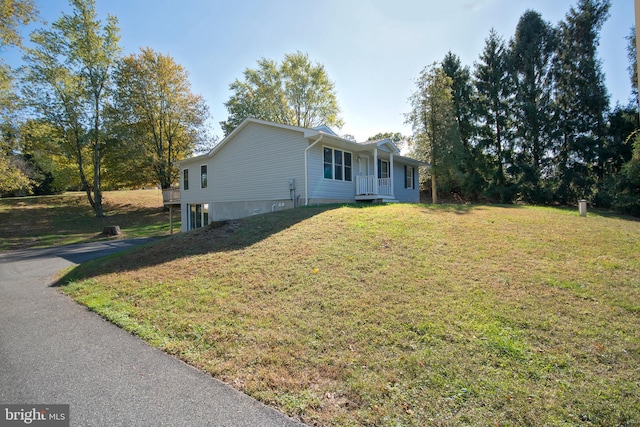 view of side of property with a yard