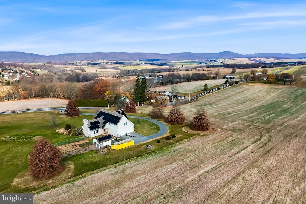 drone / aerial view featuring a mountain view and a rural view