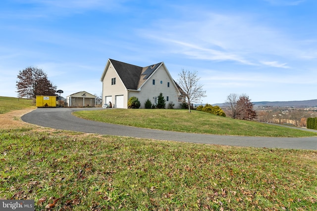 view of home's exterior with a yard and a garage