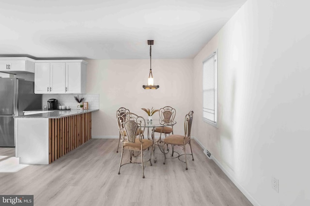 dining area featuring light wood-type flooring