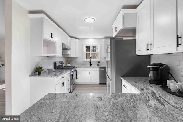 kitchen featuring stone countertops, sink, white cabinetry, and stainless steel appliances