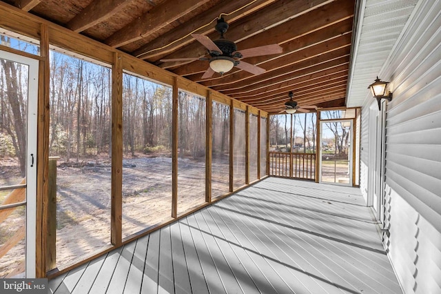 unfurnished sunroom featuring ceiling fan