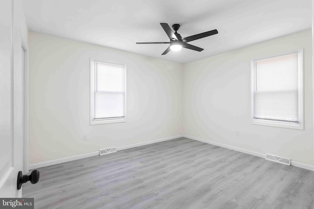 empty room featuring light hardwood / wood-style flooring and ceiling fan