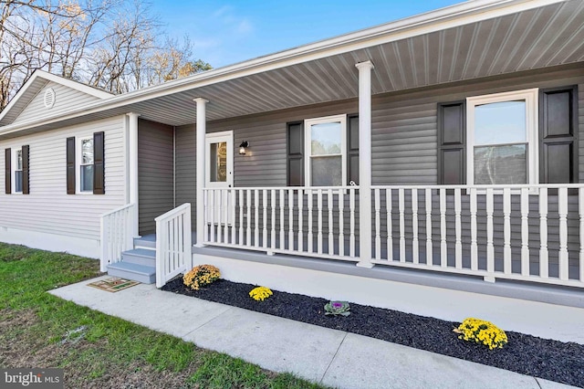 view of exterior entry featuring a porch