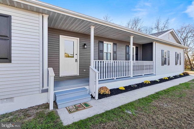 doorway to property featuring covered porch