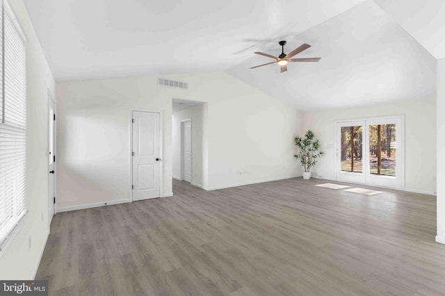 unfurnished living room featuring hardwood / wood-style flooring, vaulted ceiling, and ceiling fan