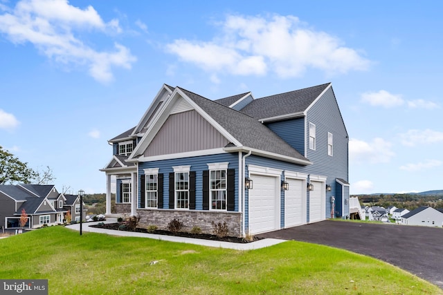 view of front of home with aphalt driveway, stone siding, roof with shingles, a front lawn, and board and batten siding