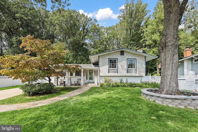 split level home featuring a front lawn