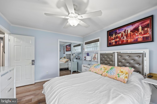 bedroom featuring ceiling fan, light wood-type flooring, crown molding, and a closet