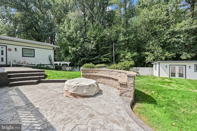 view of patio featuring french doors and a fire pit