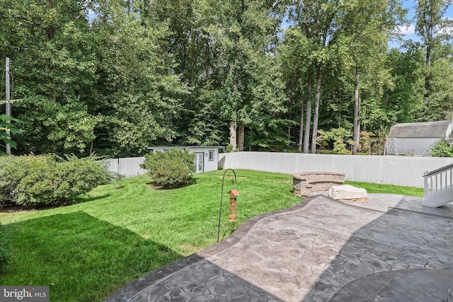 view of yard with a shed and a patio area