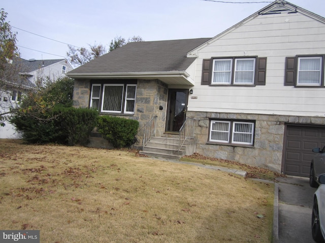 tri-level home with a garage and a front lawn