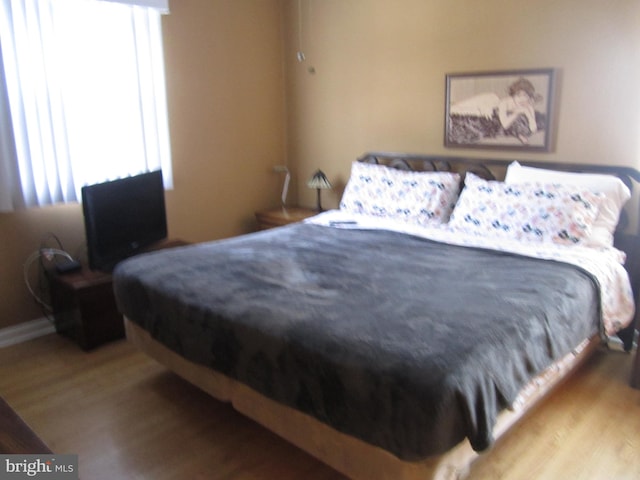 bedroom with hardwood / wood-style floors