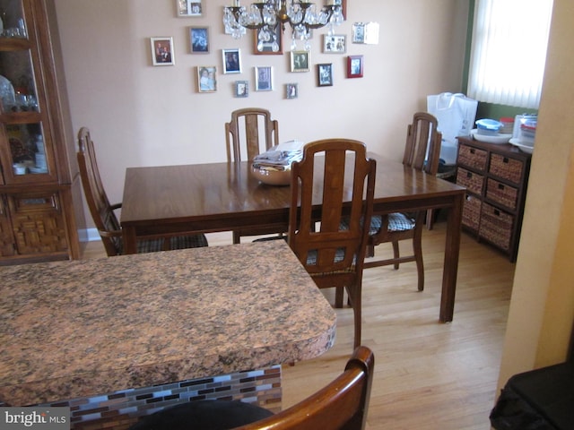 dining area featuring a notable chandelier and light hardwood / wood-style floors