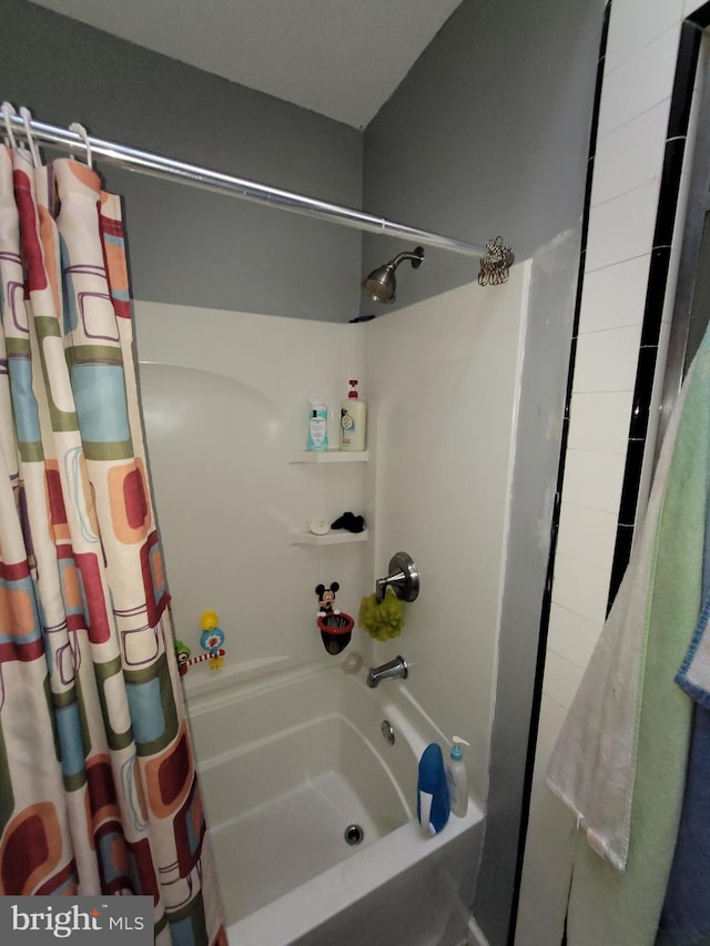 bathroom with shower / tub combo with curtain