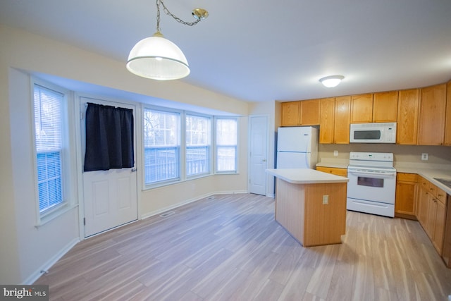 kitchen featuring light hardwood / wood-style flooring, a kitchen island, hanging light fixtures, and white appliances