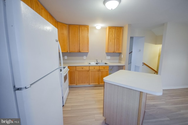 kitchen with white appliances, sink, light brown cabinets, light hardwood / wood-style flooring, and a center island