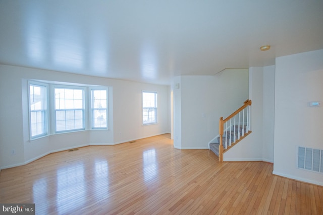 empty room with light hardwood / wood-style flooring