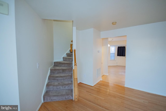 stairway with hardwood / wood-style flooring