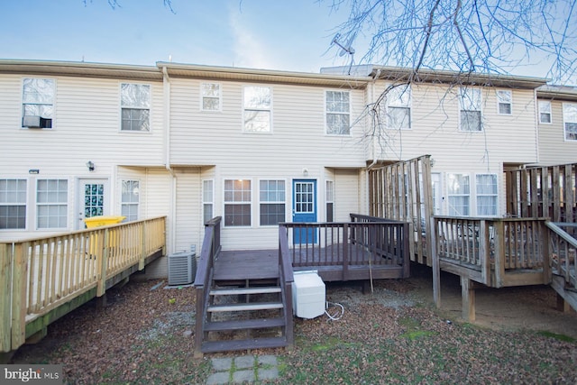 rear view of property featuring a wooden deck and central AC