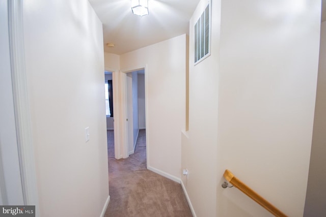 corridor featuring light colored carpet