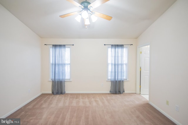 carpeted spare room featuring ceiling fan and lofted ceiling