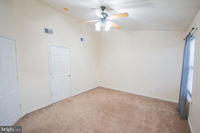 unfurnished room with ceiling fan, light carpet, and high vaulted ceiling