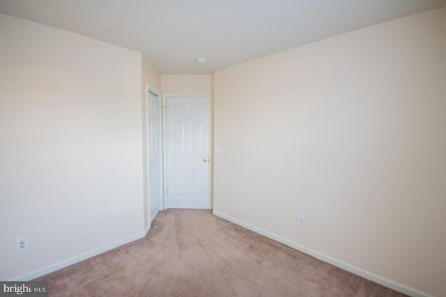 empty room featuring light colored carpet