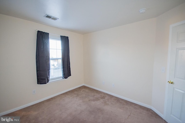 spare room with light carpet