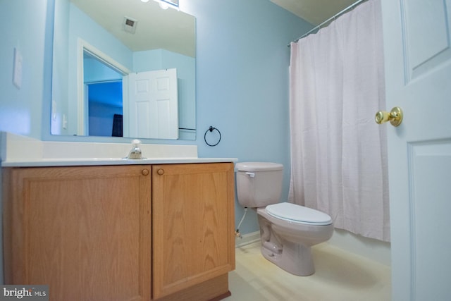 bathroom with vanity, a shower with shower curtain, and toilet