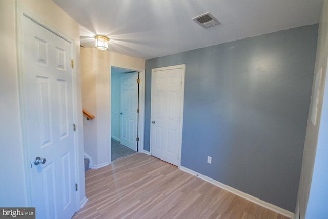 empty room with light hardwood / wood-style floors